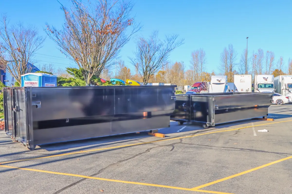 Professional dumpster rental service with roll-off container on residential driveway in Haverhill